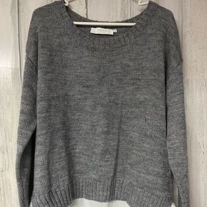 Astr knitted grey pull over with white layer.